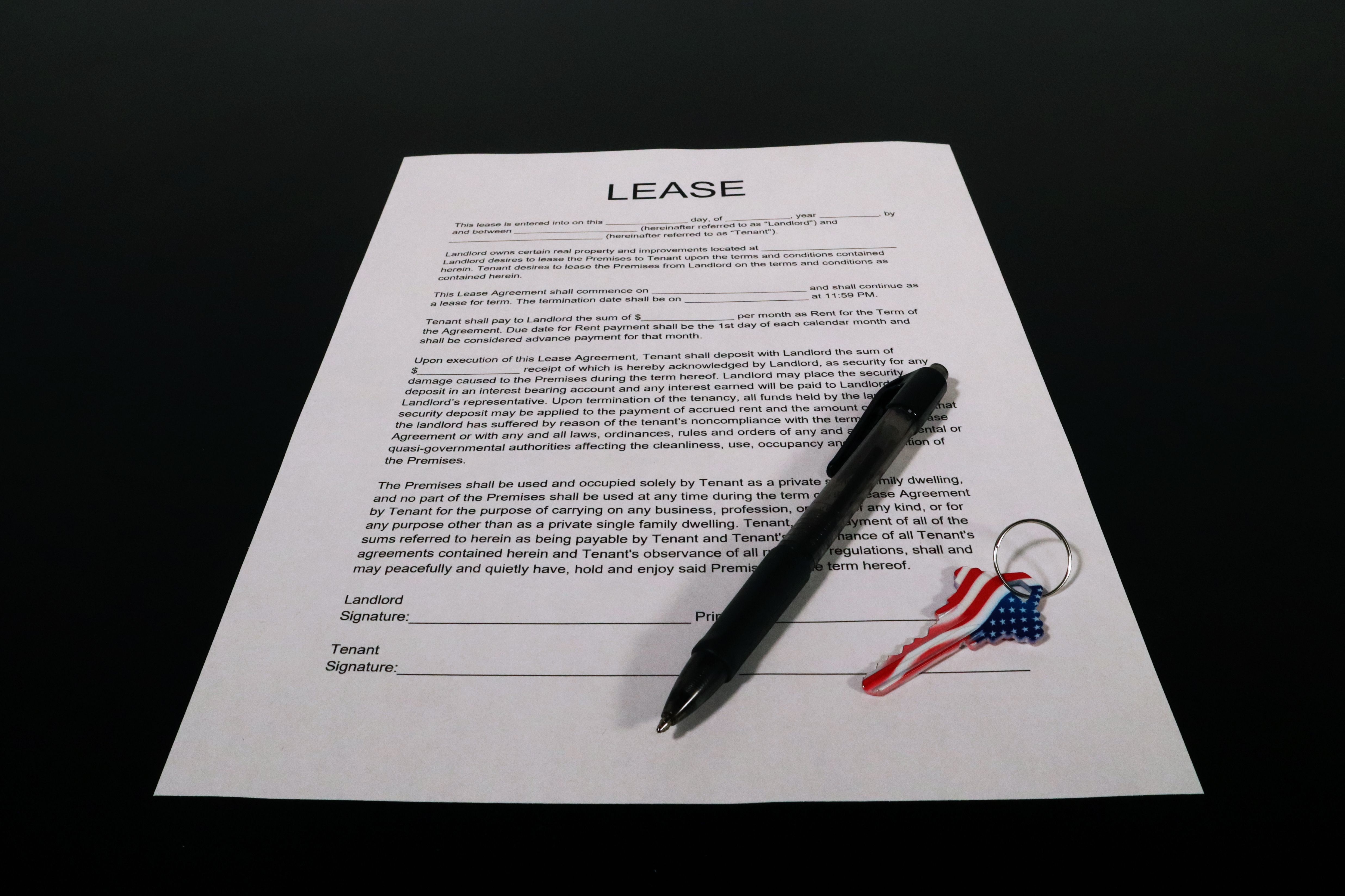 A signed lease agreement with a pen and keys